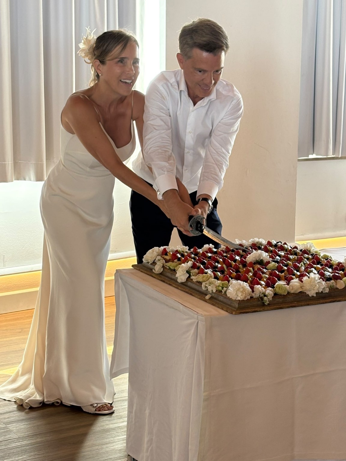 Pareja cortando juntos la tarta de boda